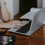 Woman using a laptop and a tablet