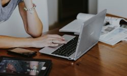 Woman using a laptop and a tablet