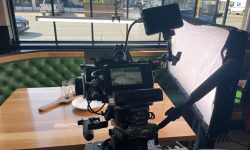 Behind video production camera capturing plate of food