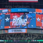 Jumbotron display at NRG Stadium showing "BULL RIDING" at a Houston rodeo event.